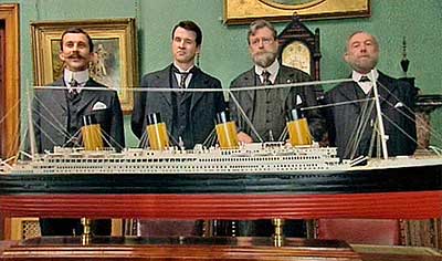 shwing off the model of the Titanic